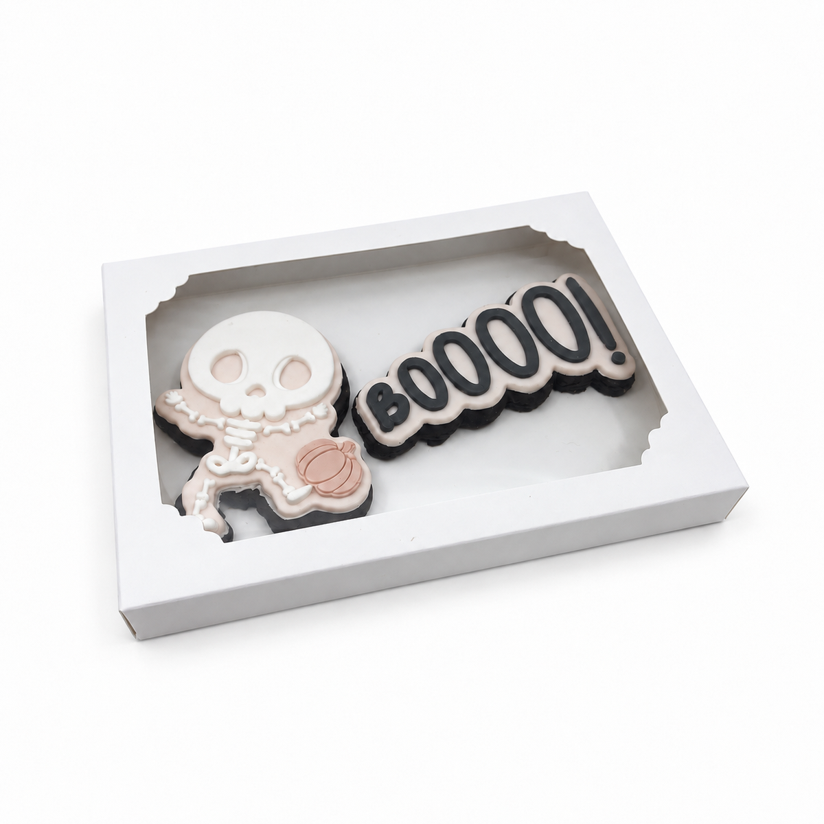 Little Bones skeleton and BOOOO fondant sugar cookies presented in a white windowed gift box.
