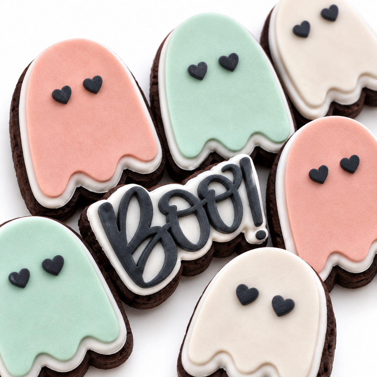 Close-up of pastel ghost and BOO fondant cookies in the Halloween-exclusive Midnight Cocoa flavour.
