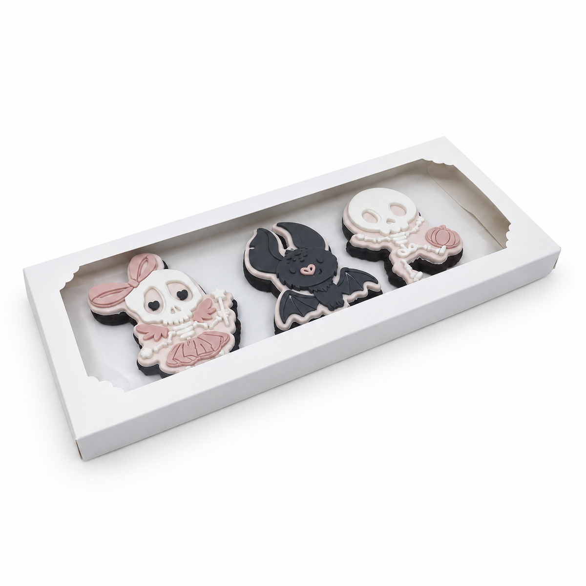 Three handcrafted Halloween sugar cookies presented in a white windowed gift box.